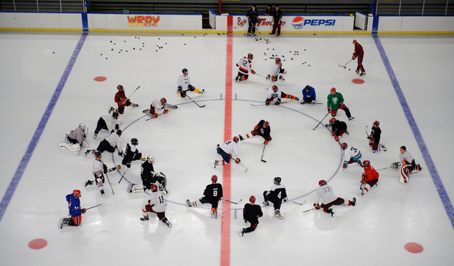 Virginia Tech hockey team members stretch during an early-season practice.
