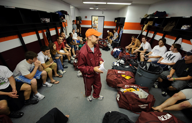 Head Coach Mike Spradlin chats with the Virginia Tech hockey team in the dressing room.