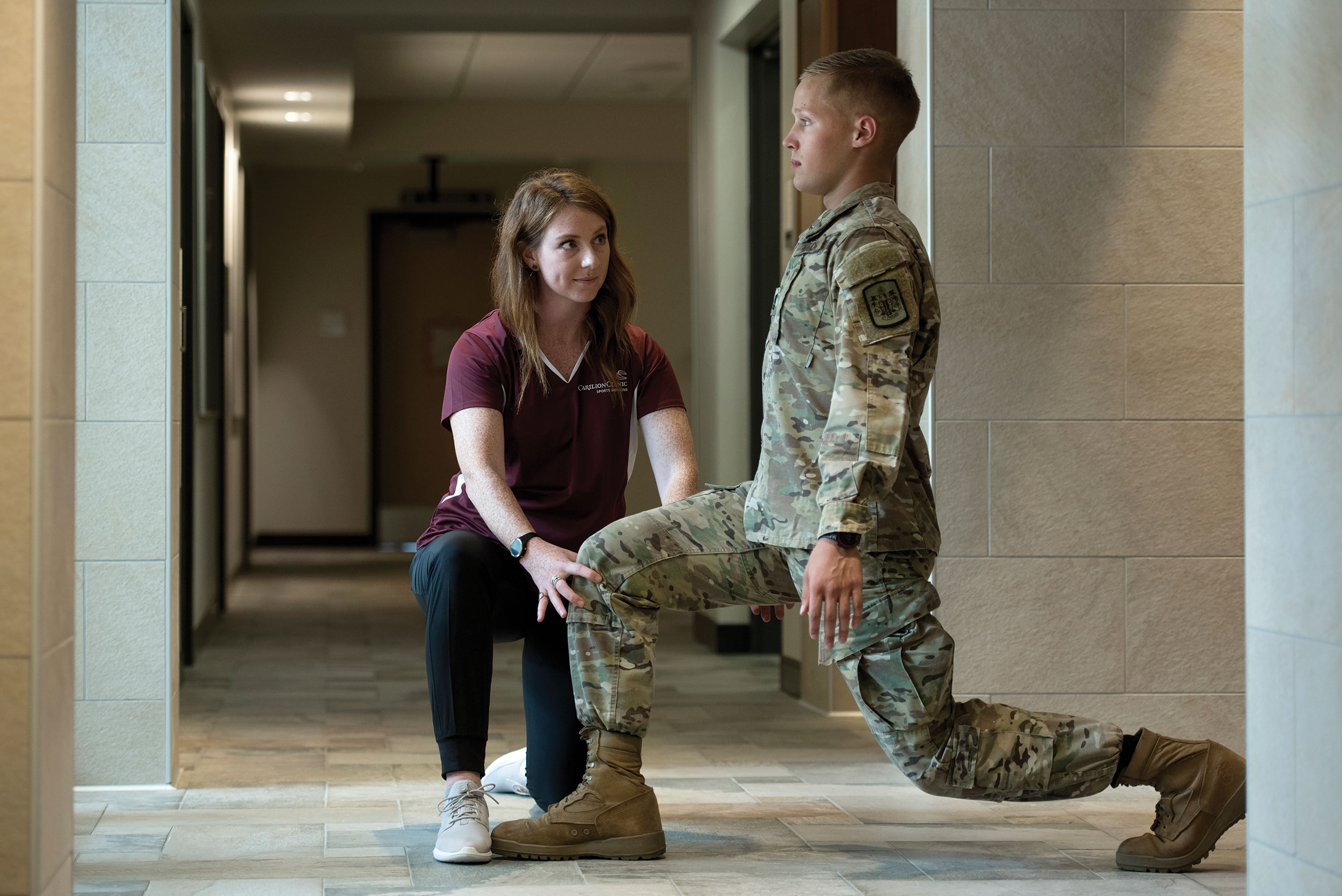 Calleigh Fangmeyer, athletic trainer, helps cadet P.J. Bourden