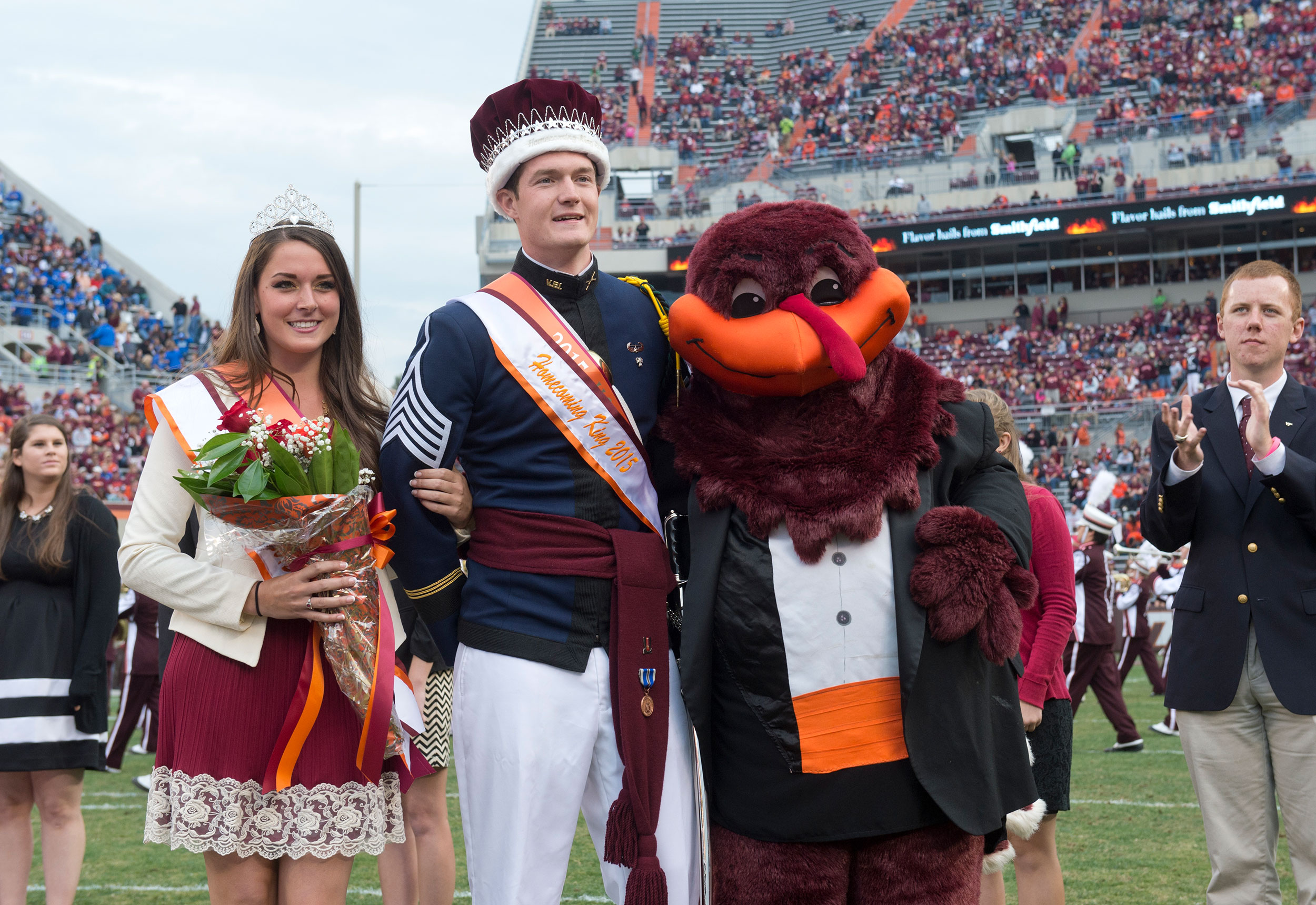 2015 Homecoming at Lane Stadium.   Homecoming King Andrew Mitchell and Queen Heather Fernandez with the HokieBird during half time ceremonies.