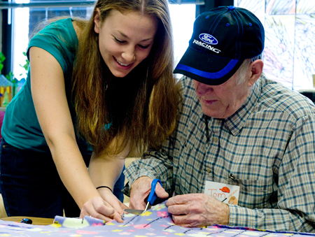 VT student working with Blacksburg-area senior citizen