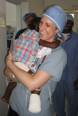 Heather Bedlion, a nurse who volunteers with PIH, comforts a patient at a hospital in St. Marc, about an hour north of Port-au-Prince.