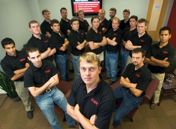 Robotics'R'Us: TORC Robotics co-founder and CEO Michael Fleming '02, '03, with his team. Photo by John McCormick.