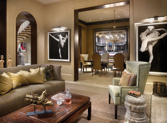 The graceful pair of Joseph Piccillo charcoal drawings, Candida Höfer's bravura photograph on the dining room wall, and the Robert Polidori peeking out from beneath the stair attest to [the] client's love of portraiture and personality. Despite the great expanse of French limestone floor, the space is warmed up by the dark, rich walnut lining the archways and openings and making its way up the Georgian-style stair. The balance of architectural materials is as important to the success of the design as the art and furnishings. From Suzanne Lovell's "Artistic Interiors: Designing with Fine Art Collections"