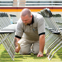 A worker preparing for commencement