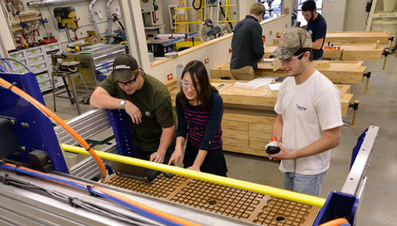 Students Matt Harrington, Suduck Kim, and Sam Savoia in the Bishop Favrao Build Lab; photo by Jim Stroup