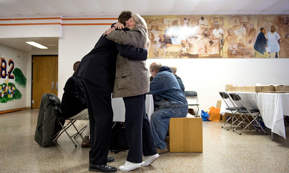 Marc Edwards receiving a hug from a Flint resident