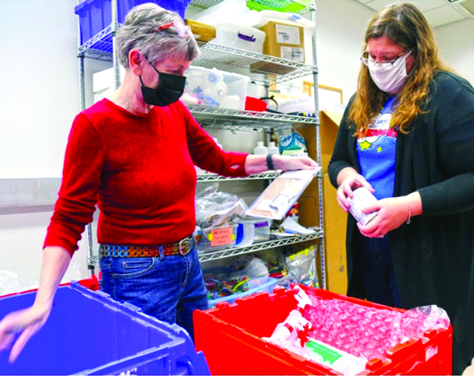 Kristi DeCourcy and Kristy Collins assemble a biotechnology kit