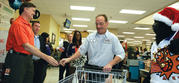 Outreach: As president of the NBA's Phoenix Suns, Brad Casper '82 (left) knows that community service events enhance the franchise's image. Courtesy of Barry Gossage, NBA Photos.