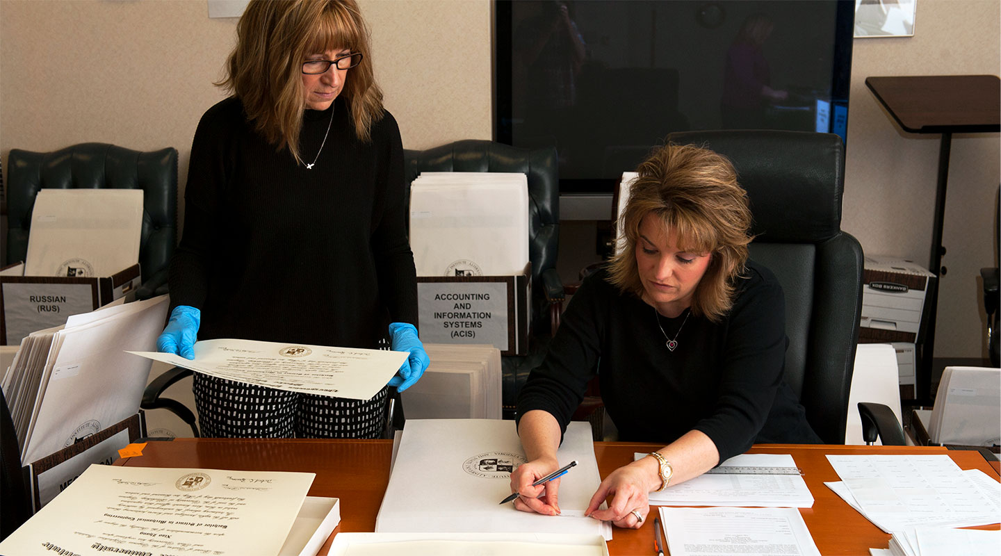 Virginia Tech staff checks diplomas