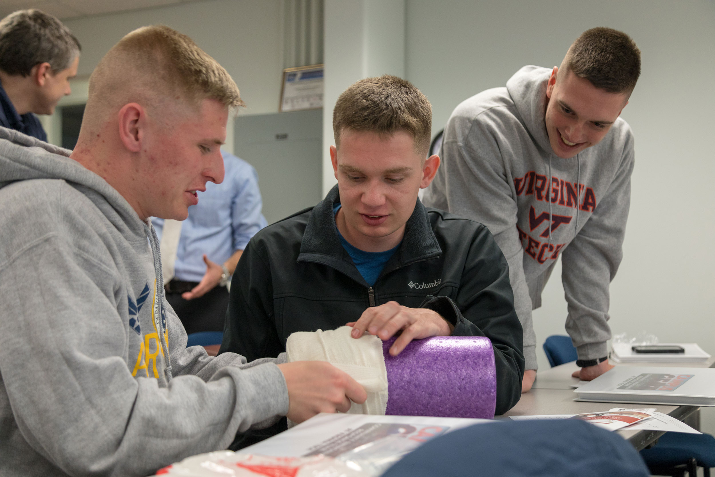 From left, sophomore meteorology majors Damion Freeman, Tyler Roiland, and Ben Blatchford practice dressing a wound during the Stop the Bleed class.