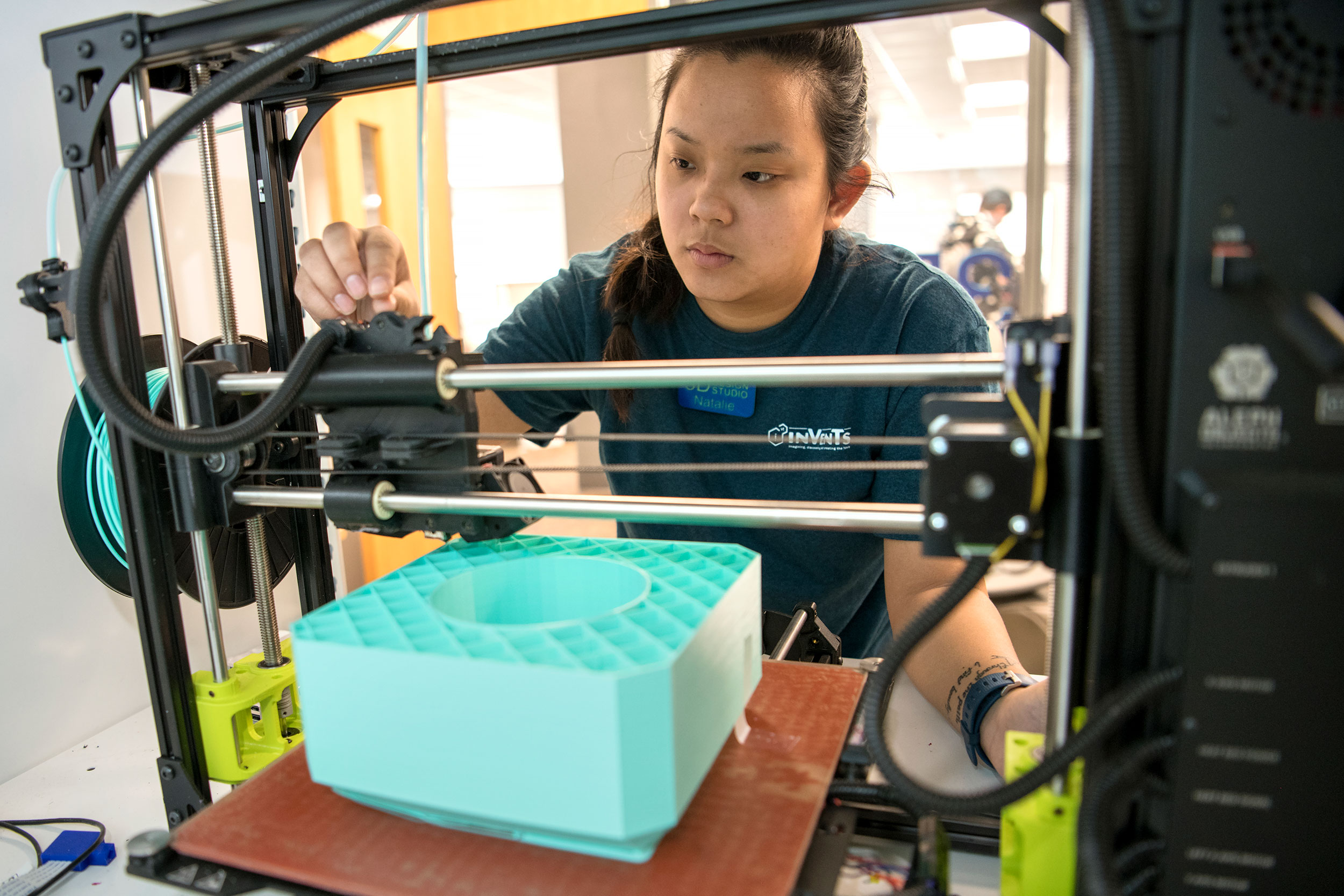 student with 3D printer