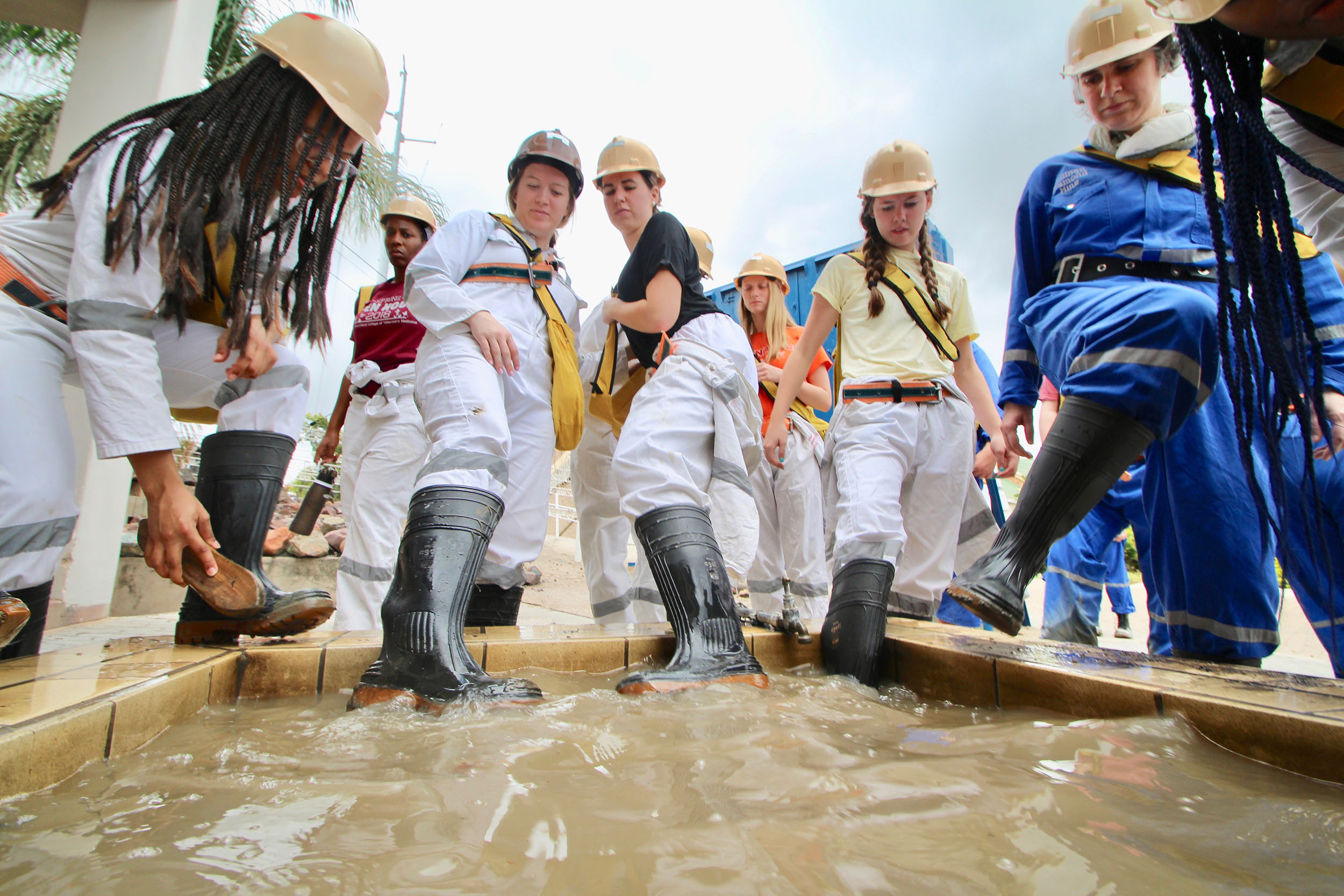 Washing boots after touring the diamond mine to make sure no diamonds are stuck on the boot soles.