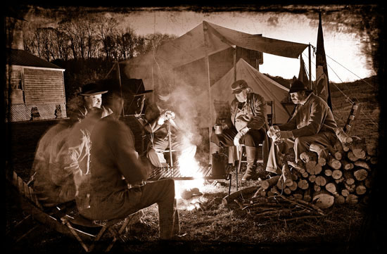 One hundred and fifty years ago, a nation roiled by war weighed heavily on soldiers like these re-enactors from the 24th Va. and 83rd Pa. Civil War Living History Organization. Here, they warmed themselves outside the Major Graham Mansion in southwestern Virginia.