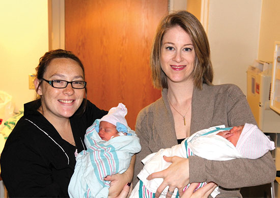 Anderson and her gestational carrier, Nicole Tyma, hold Anderson's twins—son Cole William (left) and daughter Ellis Nicole (right).