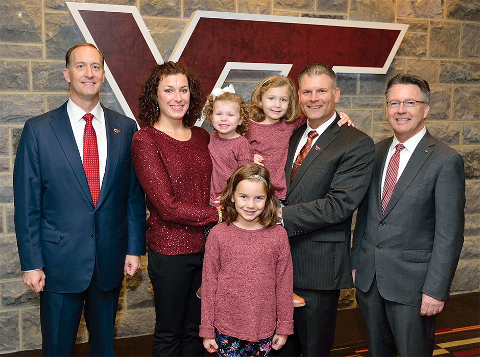 Virginia Tech Director of Athletics Whit Babcock, Justin Fuente and his family, and President Timothy D. Sands