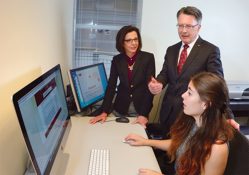 Virginia Tech President Tim Sands and Dr. Laura Sands with senior Ashley Stant